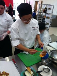 A student from North Pulaski High School's Simply Delicious restaurant competing last week. North Pulaski's team won the culinary competition. 